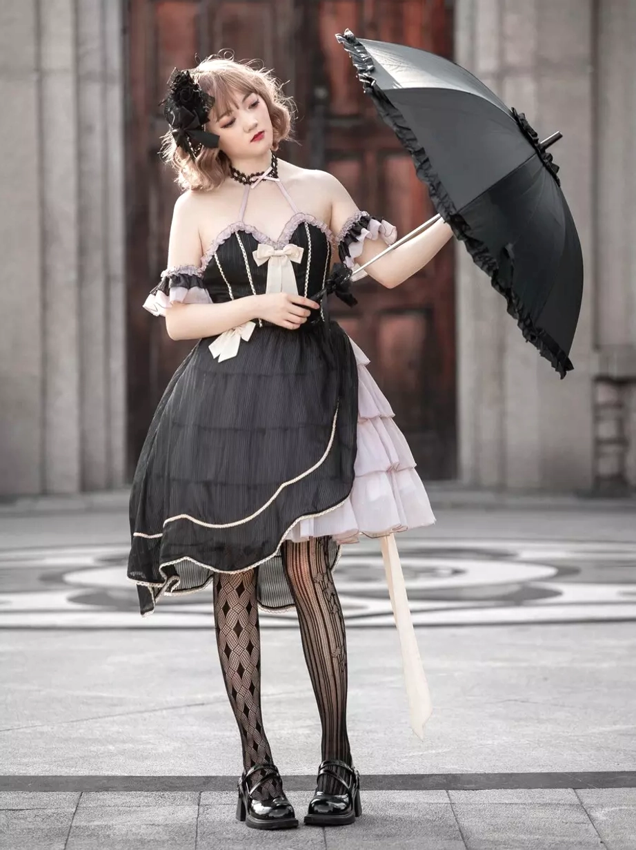Gothic lolita dress front three-quarter shooting view female model courtyard square holding black umbrella corset-style bodice bow trims accent