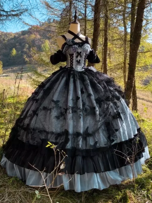 Detail view of gothic Lolita dress neckline showing cross halter design and corset strap construction