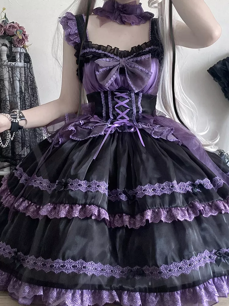 Close-up front detail of gothic sweet lolita dress featuring purple-black color block, large front bow, corset lacing bodice, sheer organza layers