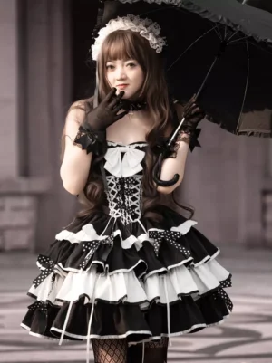 Full length gothic lolita dress worn outdoors with black umbrella maid hair accessory and fishnet stockings creating complete coordinate