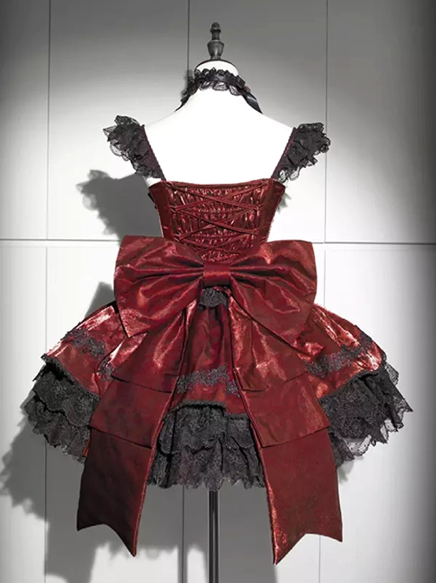 Gothic Lolita dress back close-up view featuring lace ruffled skirt hem and lace-up corset back closure with large bow