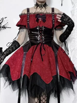 Gothic lolita dress close-up showing black tulle hem scalloped edge, lace-up corset detail, and decorative bow accent