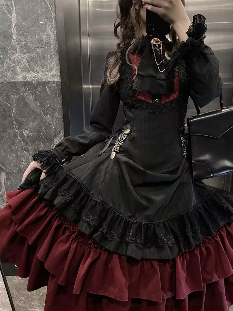 Gothic lolita long sleeve dress close-up upper body corset bodice with chain brooch burgundy lining marble elevator wall background