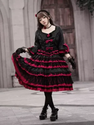 Gothic Lolita dress three-quarter front view showcasing layered ruffled skirt and flared half-sleeves with red trim accents