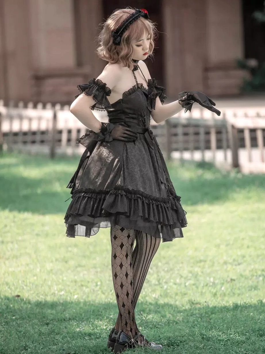 Black Gothic Lolita sleeveless dress full side standing view with off-shoulder ruffled sleeves and layered ruffled skirt hem, lace gloves