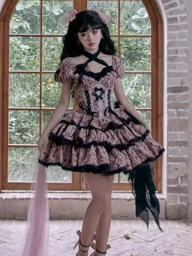 Side view pink Gothic Lolita dress with trailing pink sheer fabric, platform heels, layered ruffled skirt construction, arched brick window background