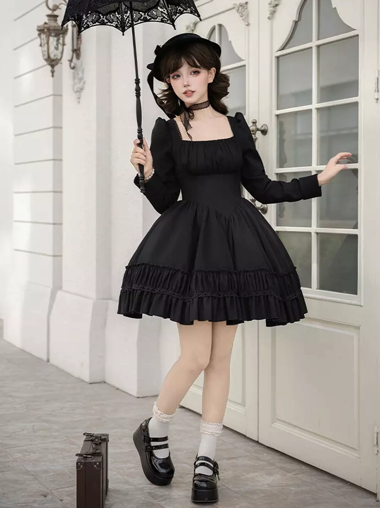 Side profile of Gothic Lolita dress with dramatic ruffled mini skirt, square choker neckline, and elegant black parasol accessory in outdoor French setting