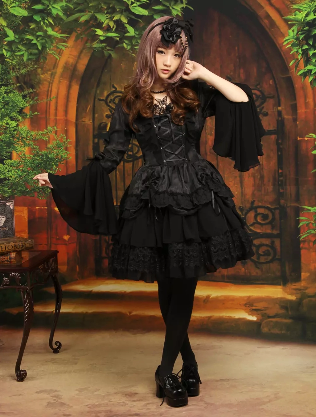 Side profile view of gothic lolita dress showing tiered ruffled lace skirt construction, long flare sleeves, and square neckline detail