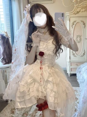 Gothic Lolita bridal dress medium close-up showing pearl choker necklace, strapless corset construction, red leg garter detail on model indoors