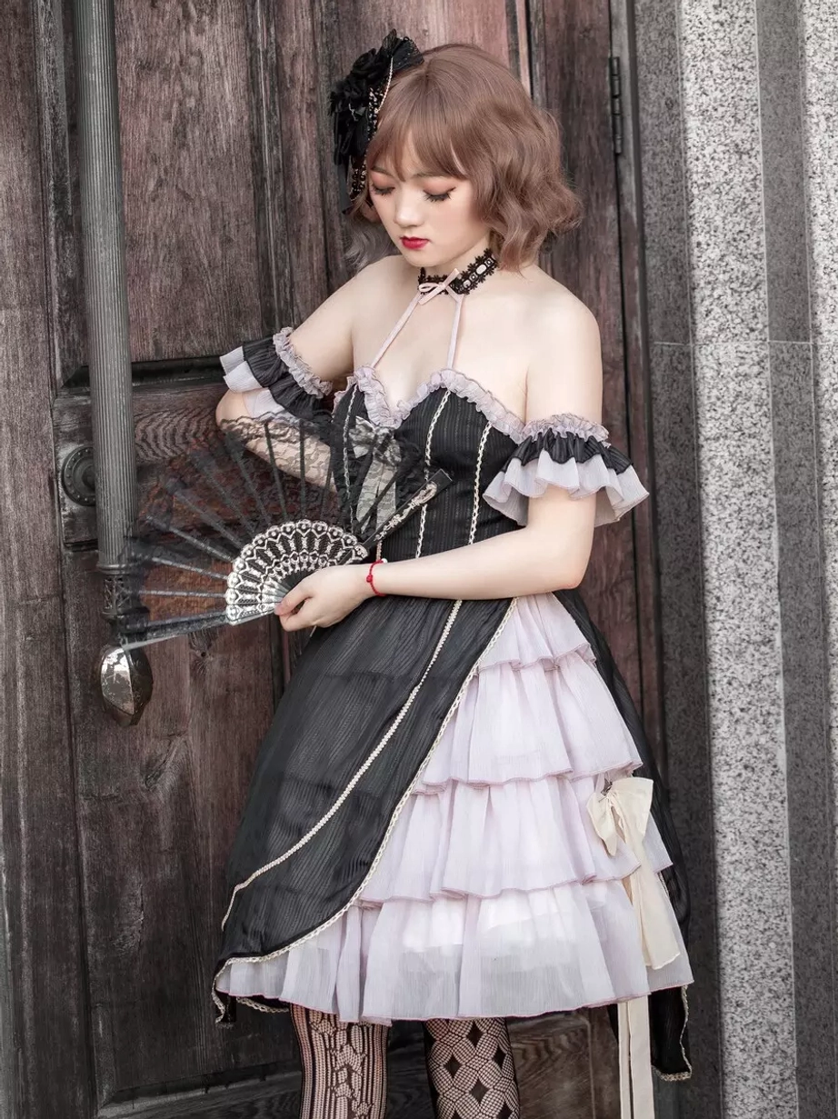 Gothic lolita dress three-quarter front view female model wooden door vintage scene holding folding fan off-shoulder silhouette layered ruffle skirt