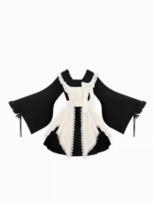 Flat lay overhead shot of two-tone black and cream Gothic Lolita dress set with color blocking, lace trims, detachable wide sleeves on white background