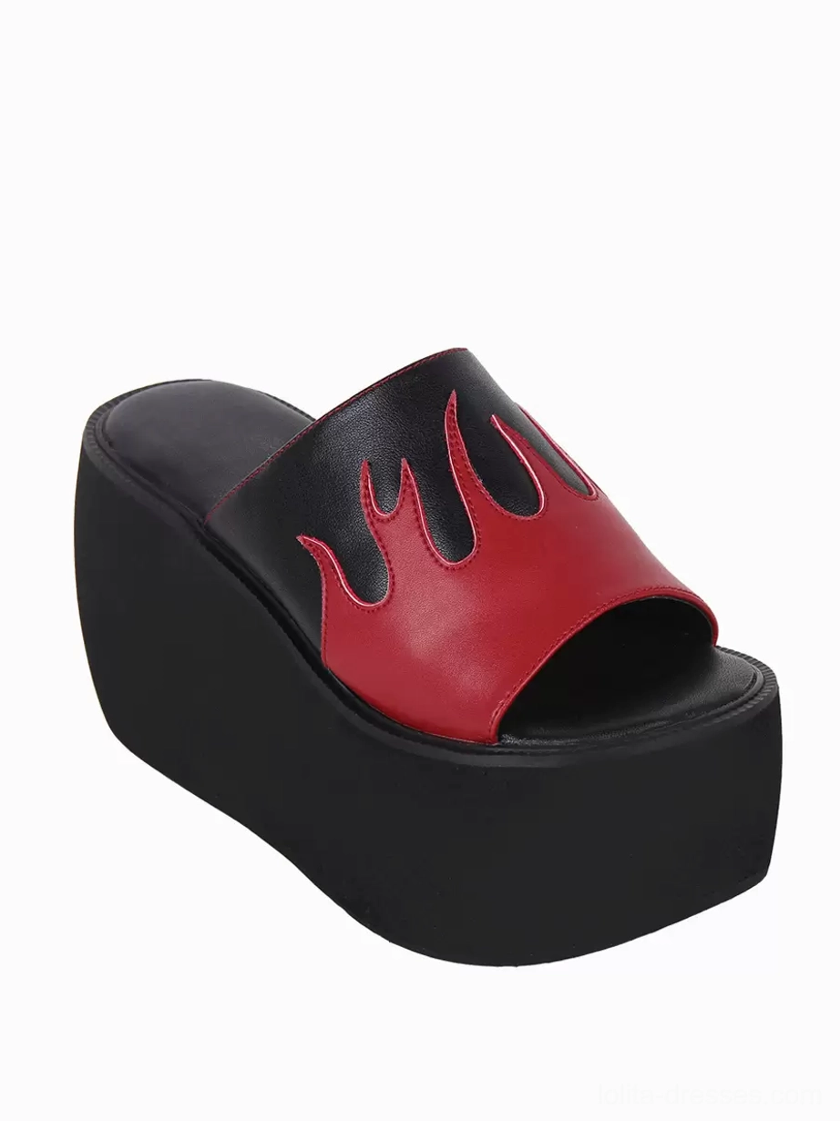 Single gothic lolita sandal three-quarter side view highlighting black wedge platform sole open toe construction and flame motif details