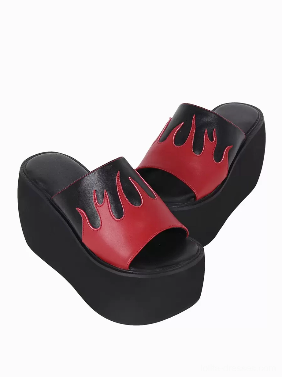 Paired flame pattern gothic lolita sandals low three-quarter angle showing slip-on style red-black upper and architectural platform construction