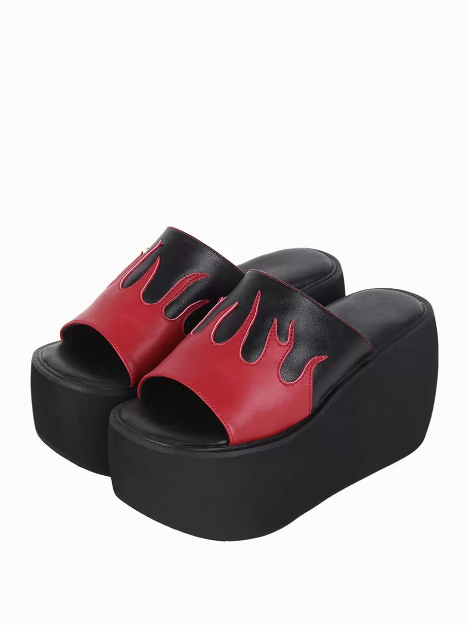 Gothic lolita flame platform sandals paired top-down view showing bold red-black color block design with flame appliqué motif and rivet details