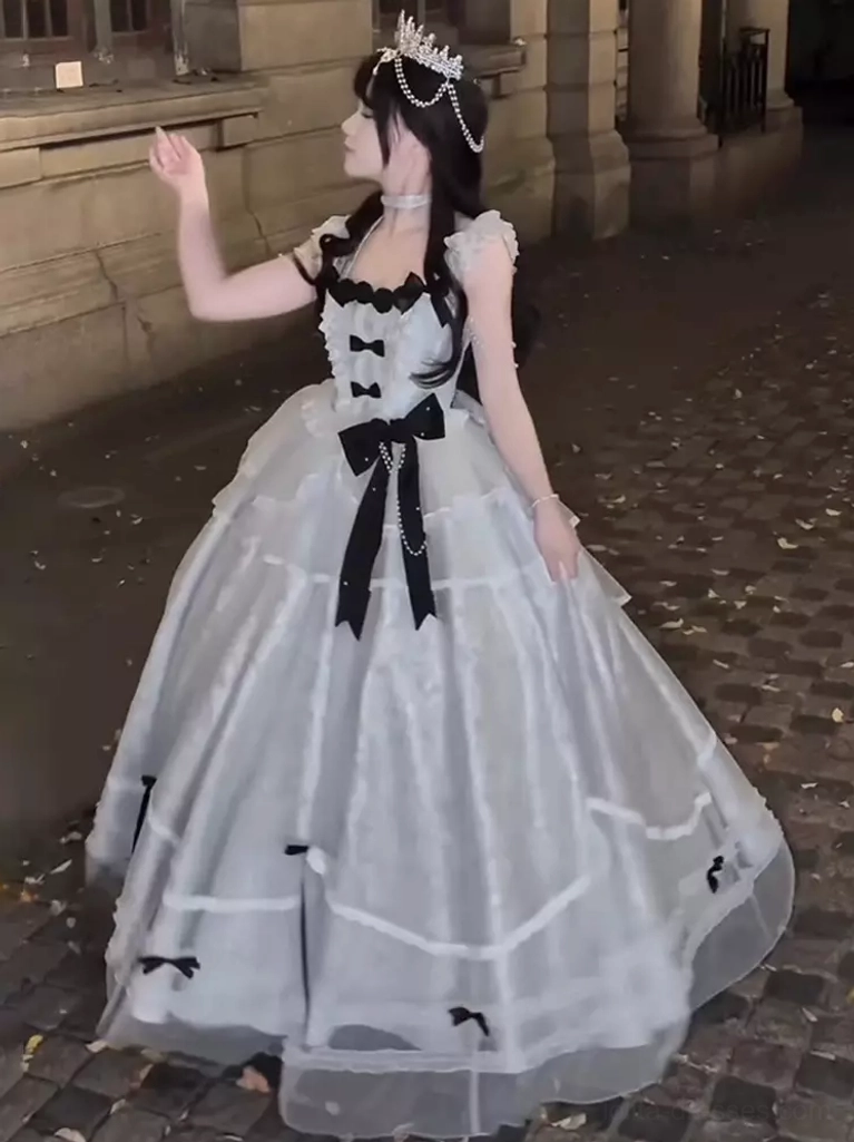 Blue gray lolita formal dress side profile vintage street outdoor model ruffled straps black bow details voluminous tulle skirt