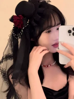 Half-face selfie view of Gothic Lolita hair accessory with black lace veil, red rose embellishment, and silver chain on model with long black hair