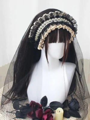 Multi-layered Gothic Lolita headband with beige and black vintage lace, attached black tulle veil, worn on mannequin with long dark wig and floral props