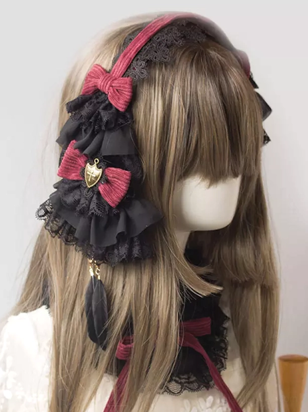 Gothic lolita headband hair accessory featuring dual wine red bows and layered black lace ruffles with charms, side profile half-face view on mannequin with feather pendants