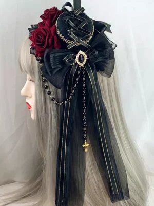 Gothic lolita burgundy and black headdress with silk bows and beaded cross tassels displayed on silver mannequin left side profile view