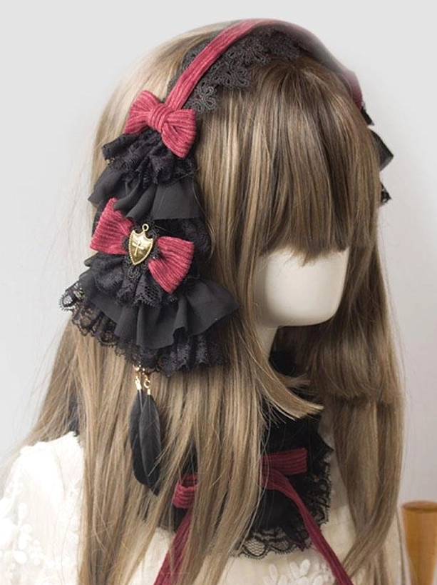 Gothic Lolita headband featuring dual wine red bows, metal shield charm, feather pendant, and multi-layered lace ruffles, front lateral view on mannequin wearing white Lolita top, showcasing full embellishment details and color coordination