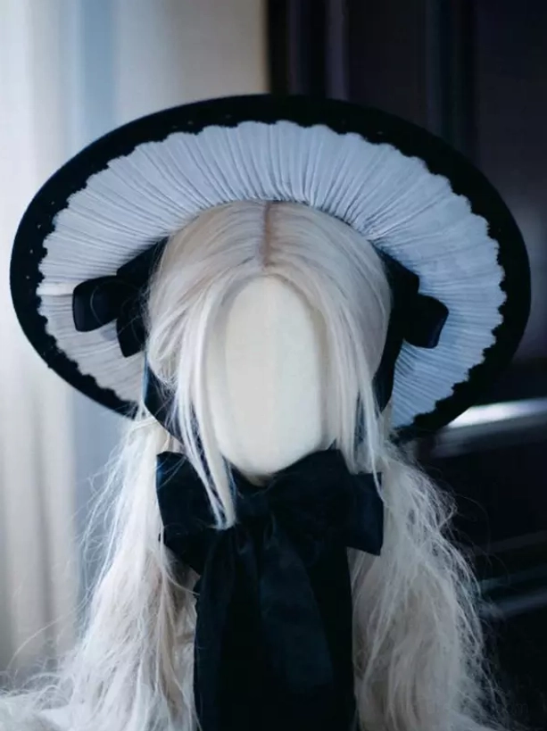 Gothic Lolita headdress front three-quarter angle showing medium front neck satin bow and hat structure detail