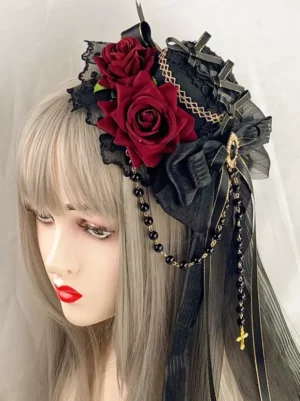 Gothic lolita headdress front three-quarter angle showing lace trim details gem brooch and hanging bead chains on mannequin