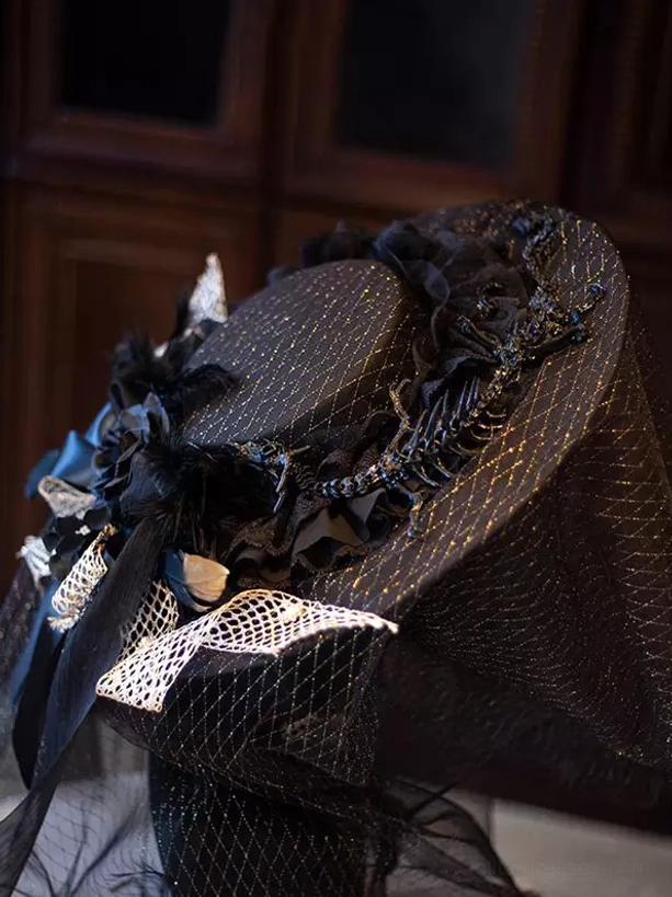 Side oblique close-up of gothic lolita wide brim headpiece with black and gold glitter fabric, branch ornaments, and attached tulle veil showing construction quality