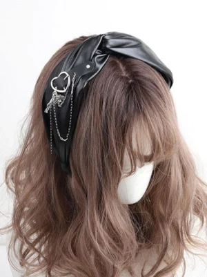 Gothic lolita heart chain headband with twisted black faux leather and silver metal pendants, left front side view on mannequin with wavy wig