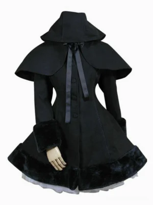 Gothic lolita black hooded cape coat with satin ribbon bow neckline detail displayed on dress form showing three-quarter front view with furry cuffs and a-line silhouette