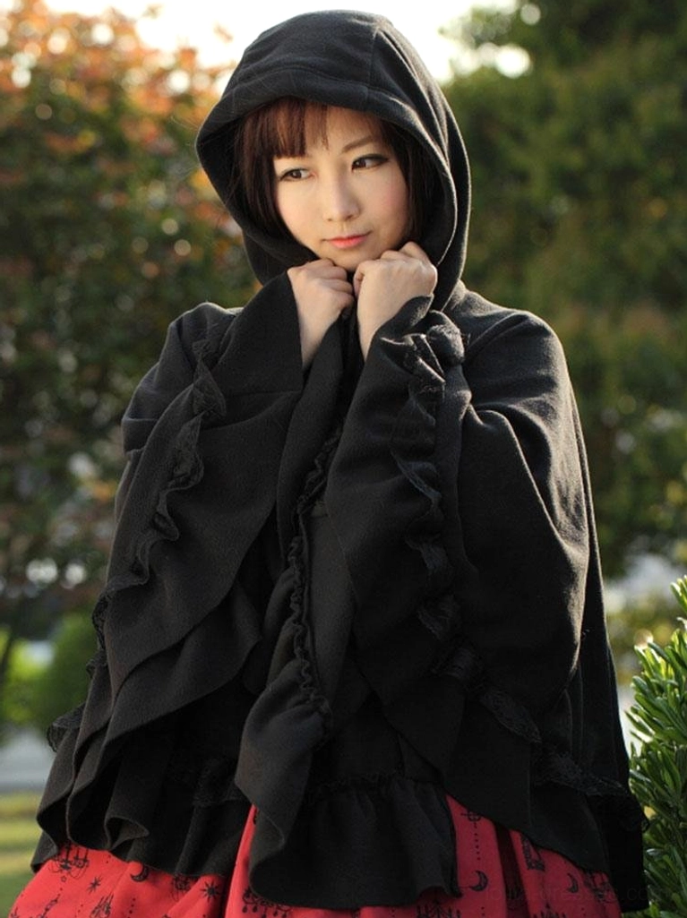 Gothic lolita hooded cape coat bust-up view with hood raised showing hands holding hood and ruffled sleeve details