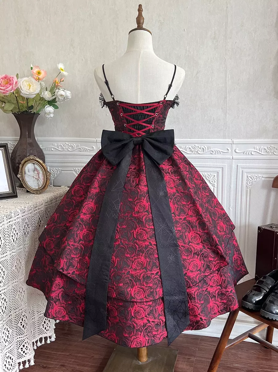Full back view of Gothic Lolita jumper skirt on display mannequin showcasing wide black waist sash, spaghetti straps and large theatrical back bow in vintage interior