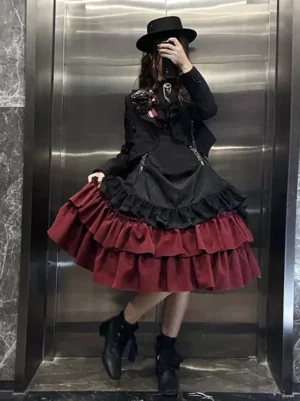 Black burgundy gothic lolita two-piece dress with tiered ruffles front view model wearing black top hat and ankle boots metal elevator backdrop