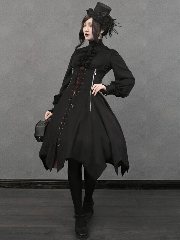 Full body gothic lolita outfit worn by female model with matching gothic styling accessories handbag and hair accessories in studio setting