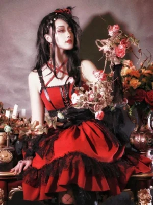 Gothic Lolita dress profile view displaying red burgundy bodice with black lace trim and cross strap neckline detail against vintage floral background