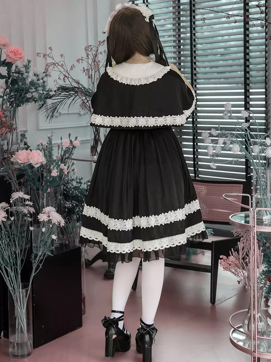 Close-up detail view of gothic lolita dress showing intricate cross lace appliques, layered ruffles, bow detail, and polyester fabric texture quality