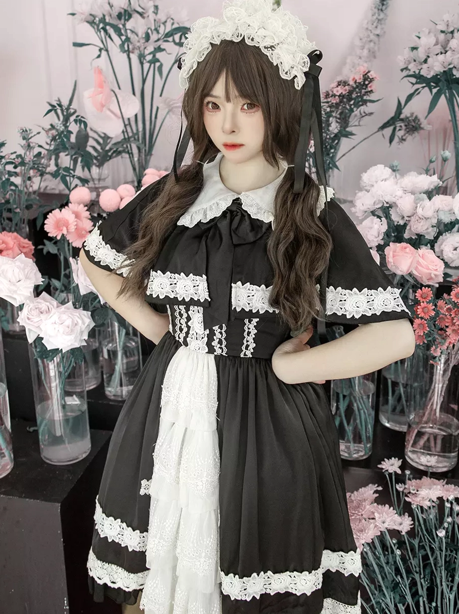 Three-quarter front view of classic gothic lolita dress with short lace-trimmed sleeves, contrast white front skirt panel, wide lace hem borders, and structured silhouette