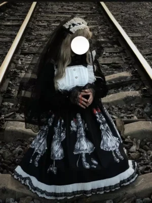 Three-quarter front view of gothic vintage lolita dress with black veil and lace gloves showing complete doll print pattern and coordinated styling on railway tracks