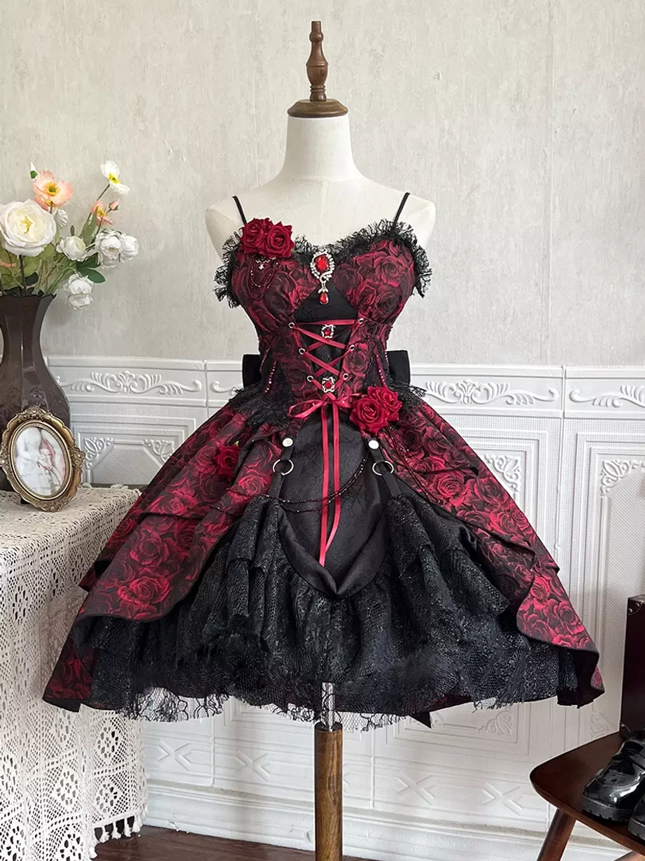 Close-up front detail view of Gothic Lolita JSK on mannequin showing chest gem ornament, ruffled lace neckline, tulle lace skirt hem and corset bodice construction