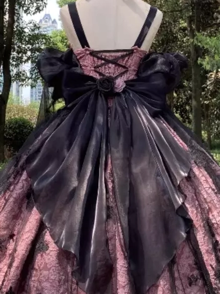 Back view of pink and black gothic Lolita JSK dress on mannequin showing large black satin back bow with rose decoration and cross straps