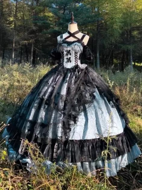 Detail view of gothic Lolita JSK gown skirt showing multi-layered tulle ruffles and floral decoration accents