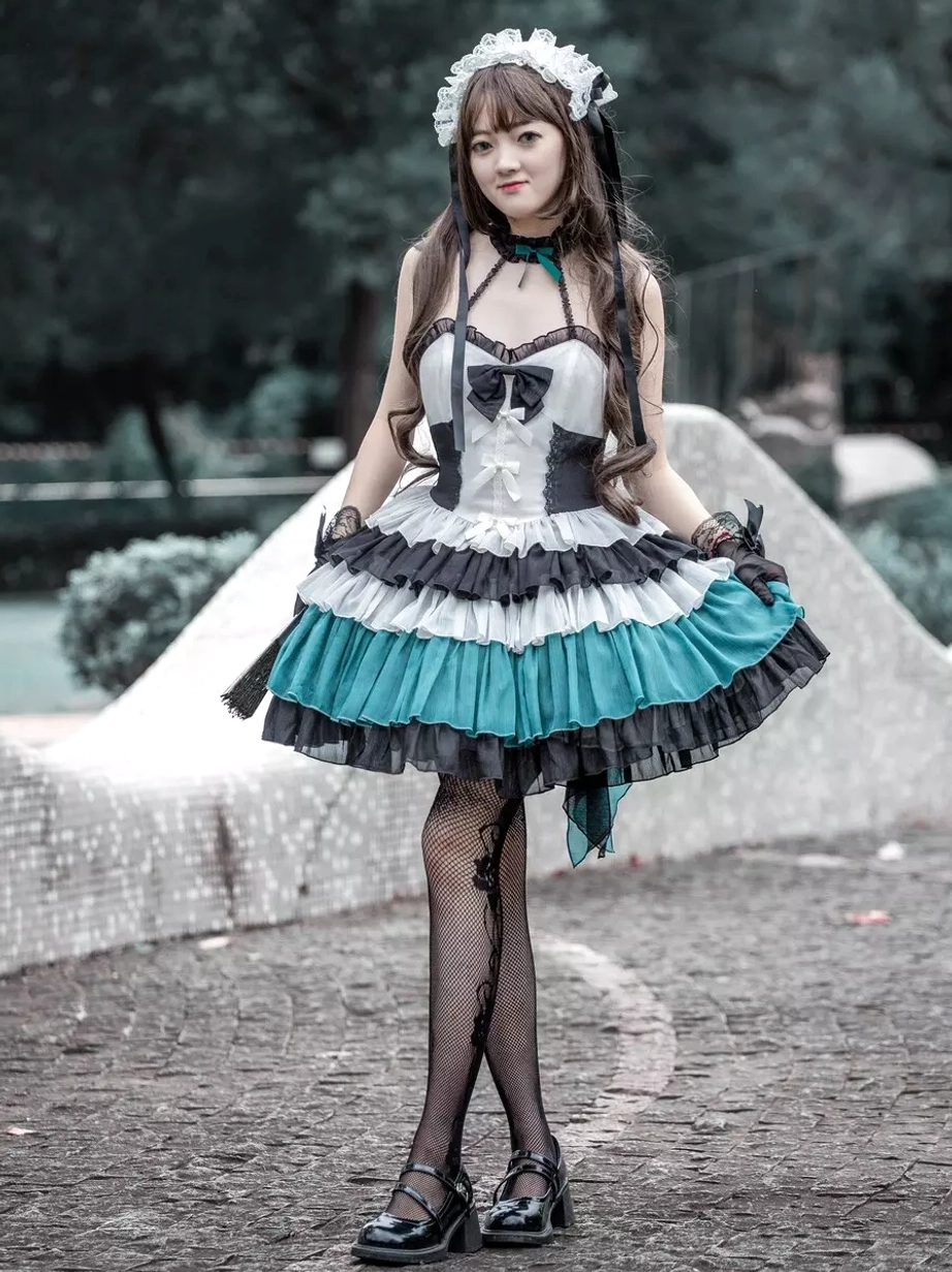 Gothic Lolita JSK tiered ruffle dress three-quarter view female model lifting skirt hem fishnet stockings