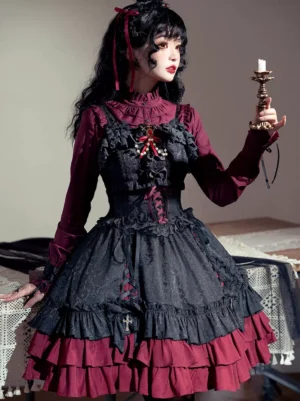 Black and wine red Gothic Lolita jumper dress sleeveless with ruffled tiered hem, color-block jacquard design, cross embellishments, three-quarter front view on female model