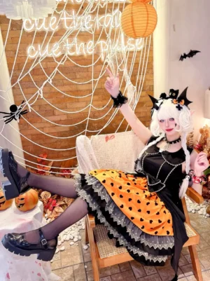 Gothic Lolita dress oblique side sitting pose displaying heart print skirt and layered lace design