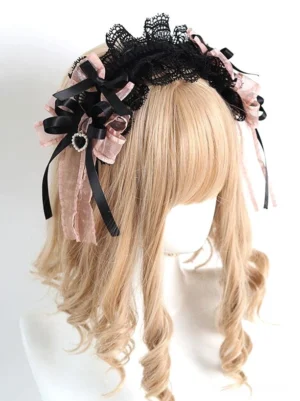 Gothic lolita lace bow headband with mixed satin and organza bows, black lace base, and heart charm pendant shown on side-front angle of blonde curly wig mannequin