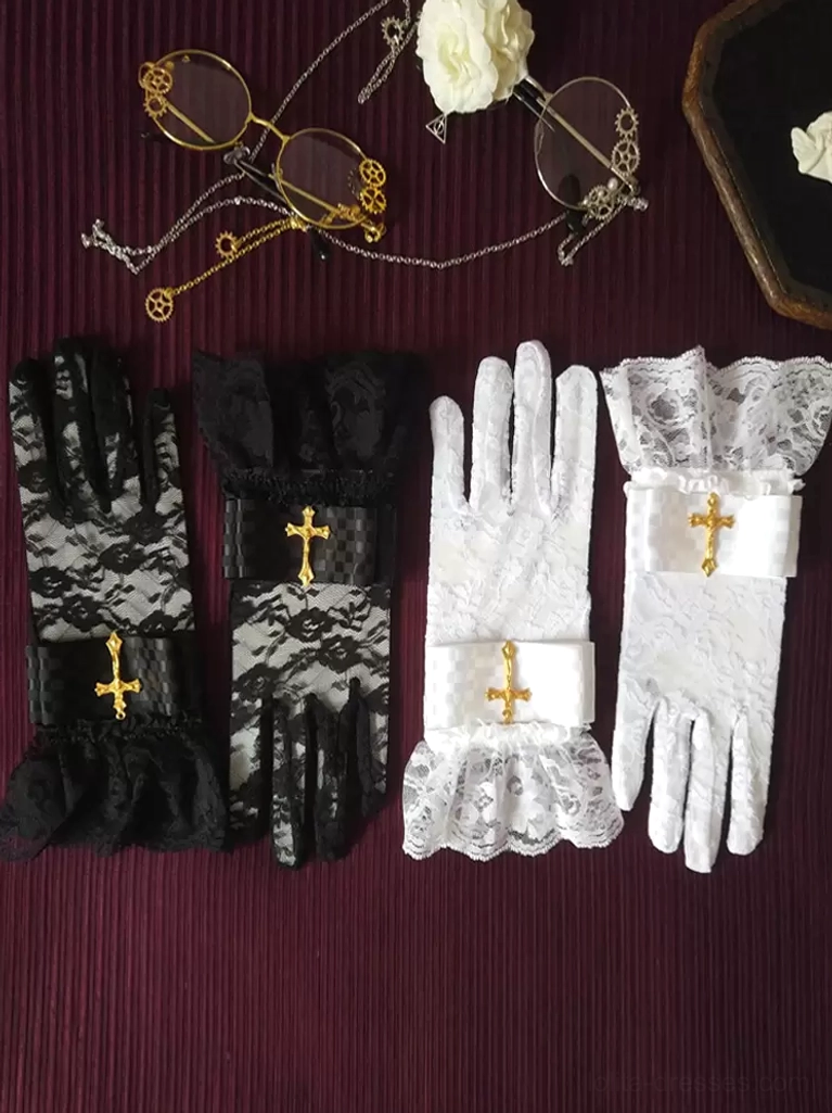 Black and white gothic lolita lace gloves with checkered wrist strap detail and gold cross ornament, styled flat lay on dark vintage fabric background for coordinate inspiration