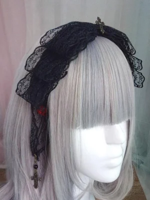 Gothic Lolita lace headdress with black ruffled lace, metal cross ornaments, red decorative accents, and dangling cross pendants shown on mannequin with silver grey bangs wig, side close-up view showcasing intricate details and dimensional lace work