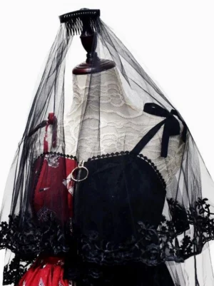 Gothic lolita black lace veil with small bow decorations and scalloped hem on model in red camisole dress