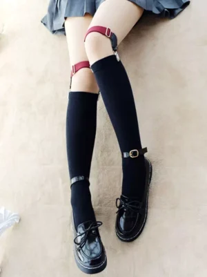 Gothic lolita over-knee socks with wine red detachable thigh garters and silver metal clips, worn with JK pleated skirt and black platform loafers - overhead view