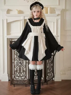 Black and cream Gothic Lolita maid dress with color blocking, wide bell sleeves, lace trims, and cream front bow on blonde model in vintage indoor setting