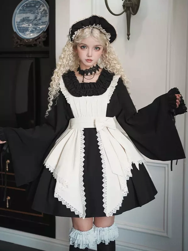 Gothic Lolita maid-style dress half front angle showing ruffled crew neckline, detachable cream lace apron, and bell sleeve details on model